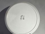 a white plate with a black and white monogram on it