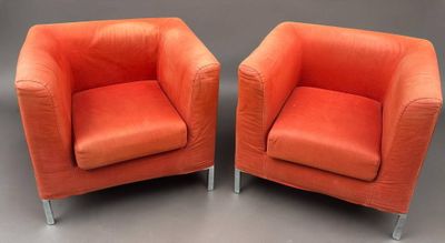 pair of orange leather chairs with chrome legs