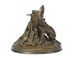 bronze statue of a man and a dog on a rock