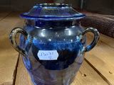 a glass jar with a tag on it sitting on a wooden table
