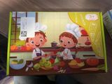two children that are cooking in the kitchen together