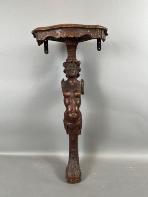 une vieille table en bois sur laquelle est posée une figurine sculptée