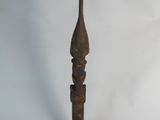 an old wooden pole with a carved top on a white background