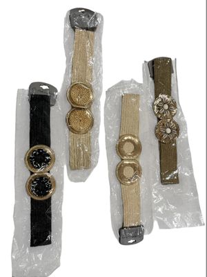 four different types of wrist watches are wrapped in plastic bags