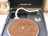 an old record player sitting in a suitcase on a table