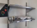 a metal shelf with a glass of water on top of it