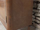 a wooden cabinet with a glass door on top of it