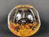 a glass ball with a face inside of it