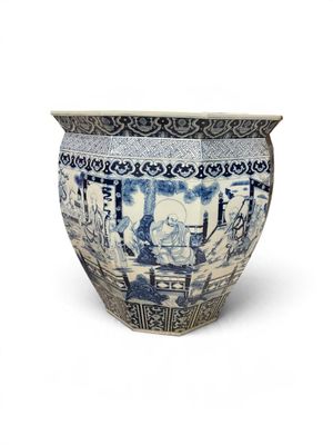 a blue and white vase sitting on a white surface