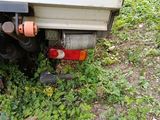 a close up of a truck ' s rear end with a hose attached to it