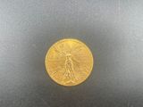 a close up of a gold coin on a black surface