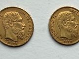 two gold sovereigns, one of which has a head of a man and the other of a woman