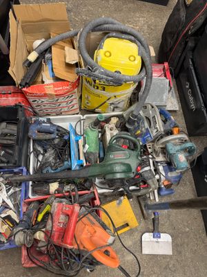a pile of assorted tools sitting on the floor