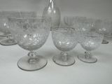 a group of glasses and a pitcher on a table