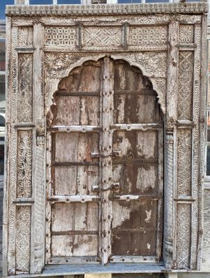 doorway of an old building with a wooden door and a window