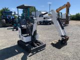 the back end of a small excavator parked in a parking lot