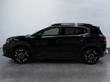 the black suv is parked on the concrete floor in the room