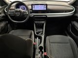 the interior of a small car with a steering wheel and dashboard