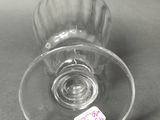 a wine glass with a sticker on it sitting on a table