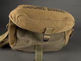 the back of a tan bag with a black logo on it