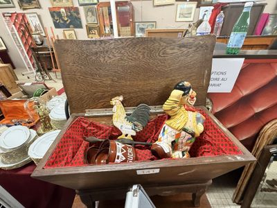 a wooden box with a statue of a clown inside of it