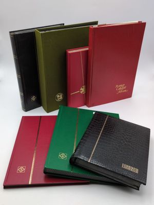 a group of four different colored books sitting on top of each other