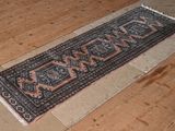 a long rug on the floor on the wooden floor