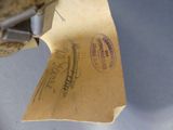 a piece of paper with a stamp and a pair of scissors on it