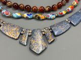 three necklaces with different colors and designs on them on a table