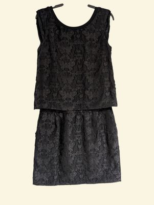 a black dress on a hanger on a white background