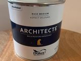 a can of paint sitting on top of a wooden table