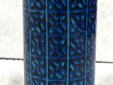 an image of a blue and yellow vase on a white surface