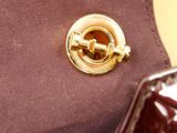 a close up picture of a purse with a pin on it