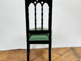 an image of a black chair sitting on top of a wooden floor