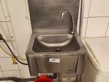 a sink and a bucket in a small room