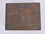 a small wooden box with metal decorations on it