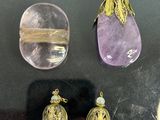 three pieces of jewelry on display in a glass case
