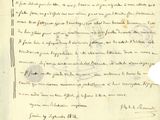 un vieux document écrit posé sur une table