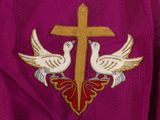 a cross and two doves on a purple jacket