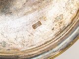 a close up of a metal object on a white surface