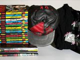 books and a baseball cap are on a table next to a pile of dvds