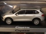 a silver toy car in a box on a table