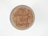 a small piece of pottery with writing on it