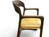 an image of a wooden chair with a yellow cushion on it