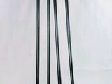 several black and red metal poles are stacked on top of each other