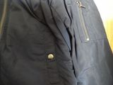 the jacket is black and has a zipper on the front