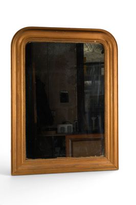 a mirror that is sitting on a table in front of a wall