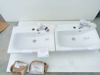 two white sinks sitting on top of a white counter