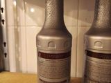 two bottles of syrup sitting on a counter top