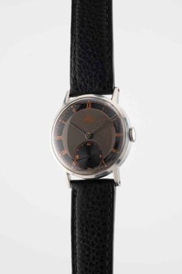 a close up of a watch on a black strap on a white surface